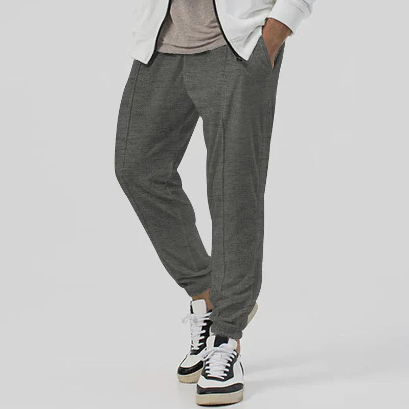 Men's casual track sweatpants in loose tapered straight-leg design showing army green colour option