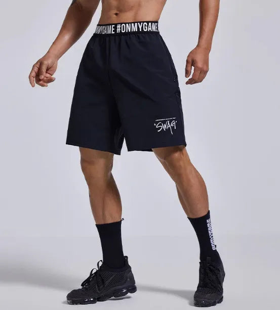 Men's grey workout shorts with loose cropped fit and letters detailing on elastic waist