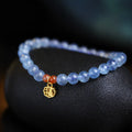 Aquamarine natural crystal bead bracelet with sequin charms on elastic cord