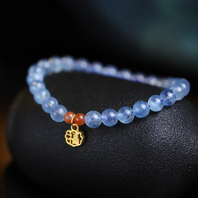 Aquamarine natural crystal bead bracelet with sequin charms on elastic cord