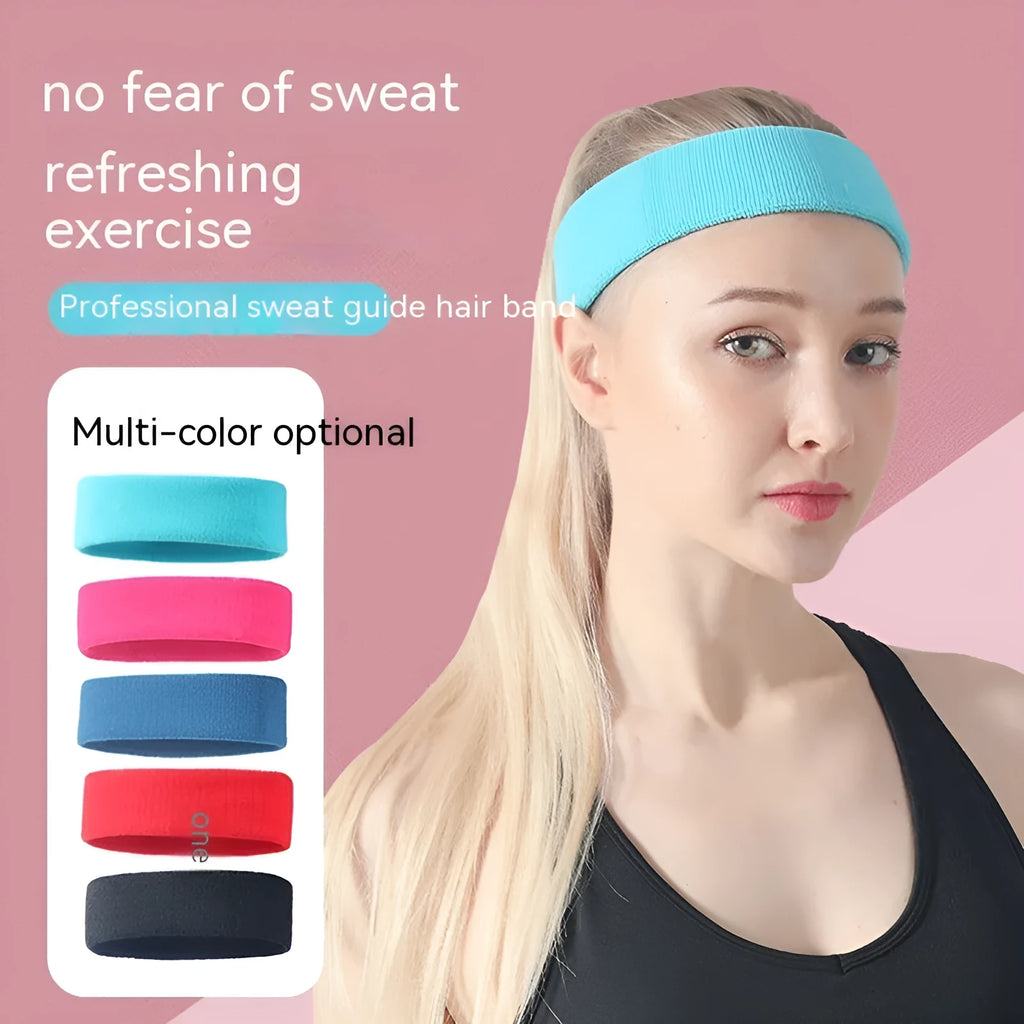 Elastic solid colour sports sweat band in black, shown on a forehead.