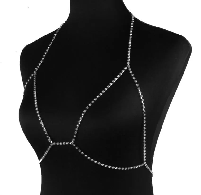 Women's rhinestone metal body chain necklace in gold on a model showing torso wear