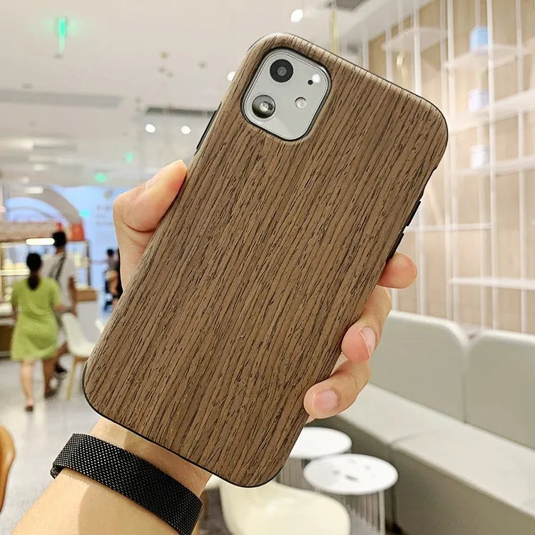 A slim wooden back cover case for an iPhone, showing the natural grain of rosewood or bamboo.
