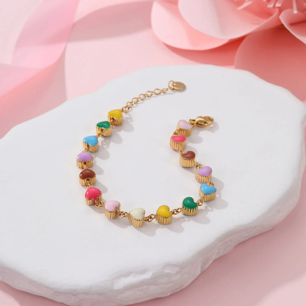 Women's adjustable heart pendant bracelet with colourful oil accents in gold or steel finish