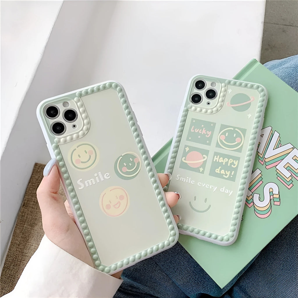 Green TPU iPhone case with geometric pattern and smiley faces in a polka dot frame for multiple models.
