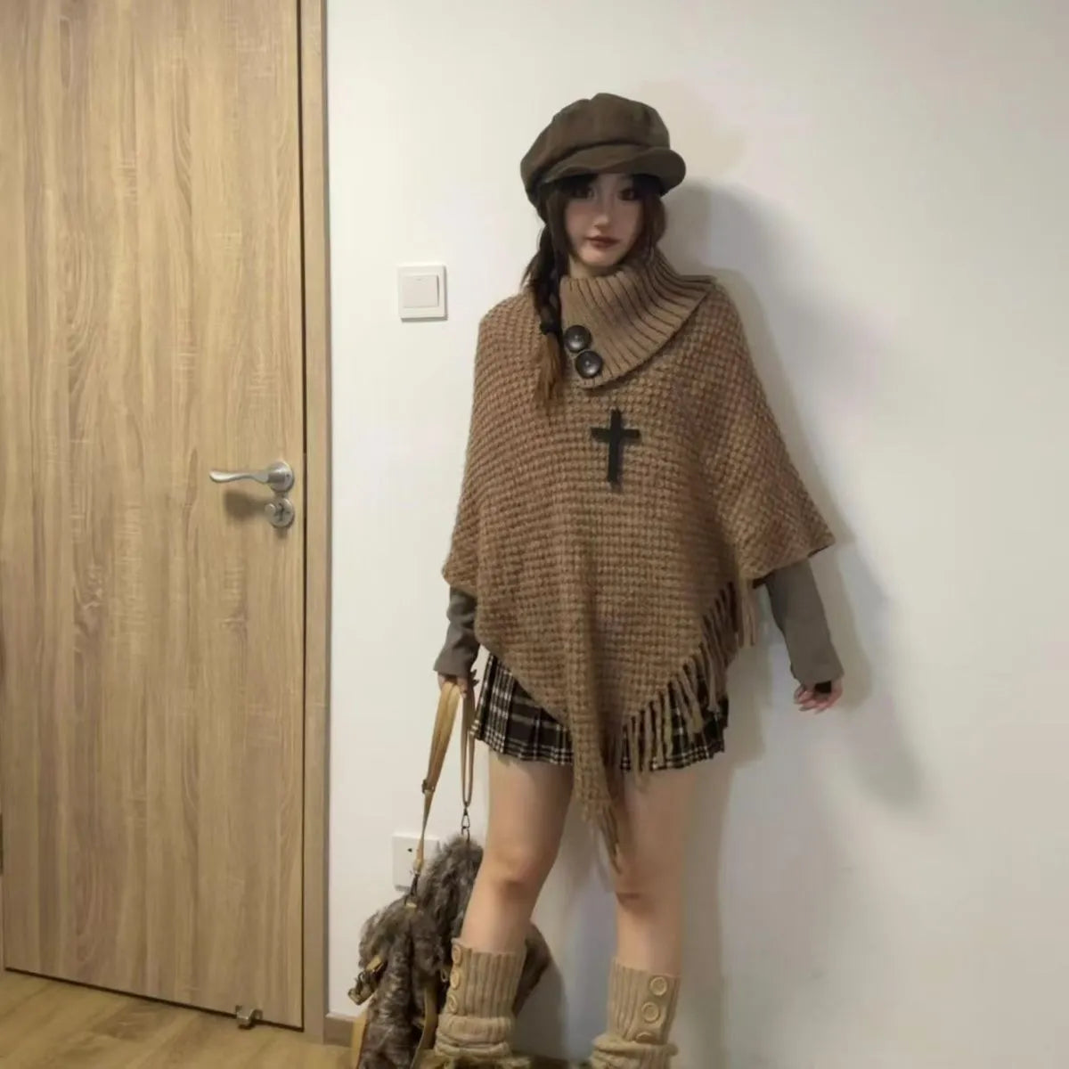 Women's casual plush triangle shawl cape with tassel details in a cashmere and acrylic fabric blend.