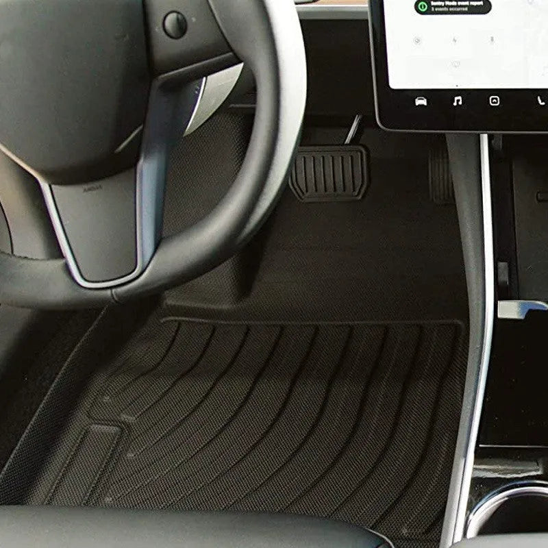 Custom rubber floor mats for Tesla cars with a textured TPE driver footrest section.
