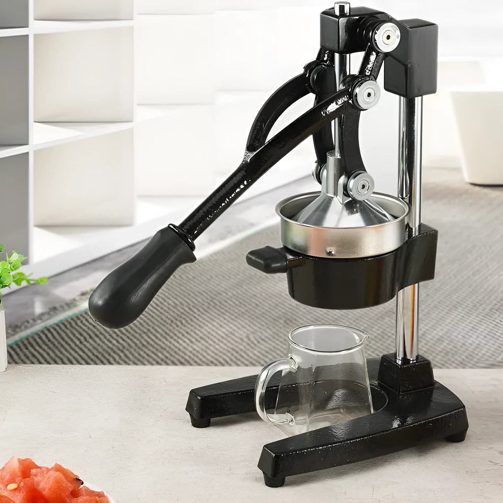 Black cast iron manual citrus juicer with stainless steel cone on a white background.