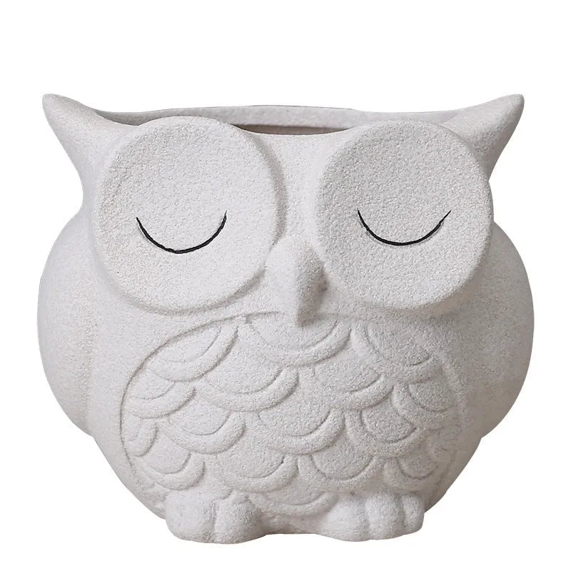 Handmade frosted ceramic flower pot with cartoon owl design, shown in light pink colour.