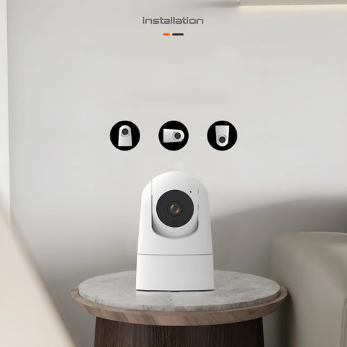 White indoor security camera with lens on a stand, showing compact design.