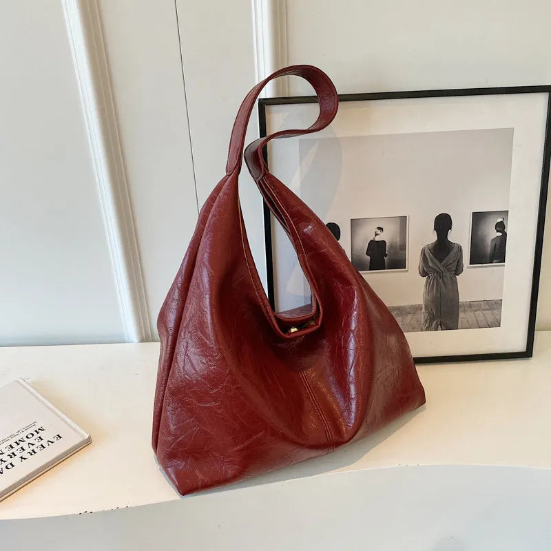 Soft leather shoulder bag in street style with sandwich pockets, shown in multiple colour options.