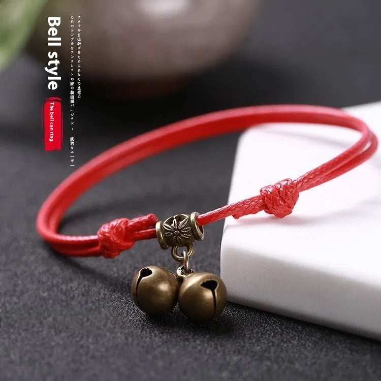 Small dog wearing adjustable nylon rope collar with brass bell in black, red, or coffee colour