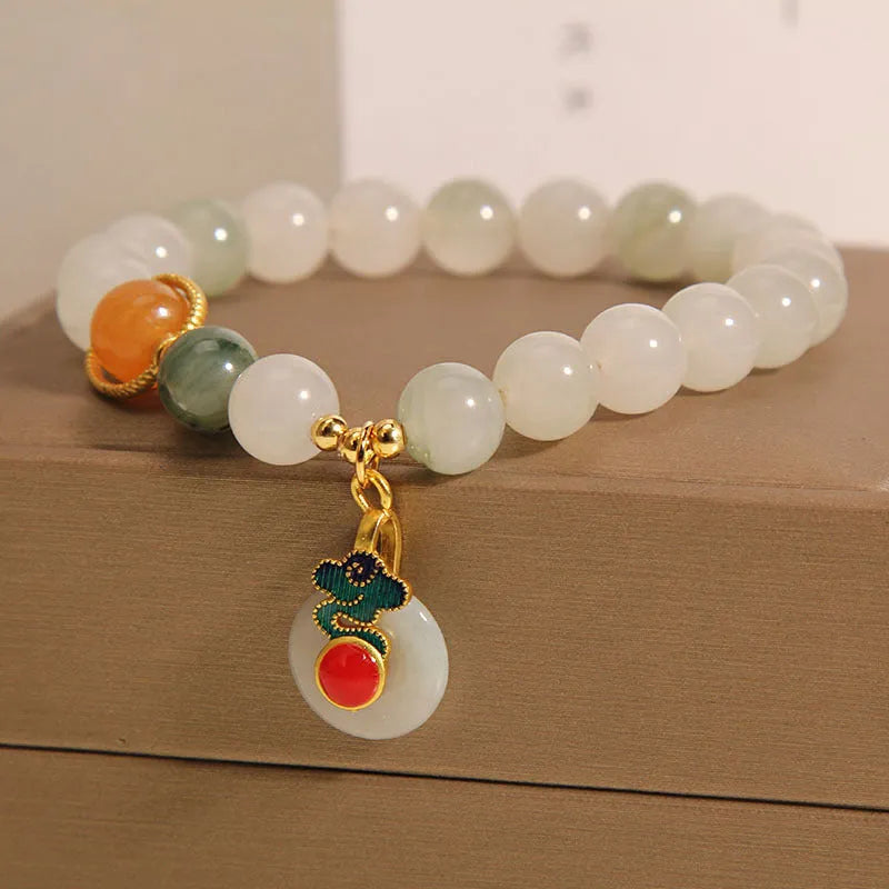 Women's ice jade bracelet with pearl accents and carved Xiangyun peace jade buckle