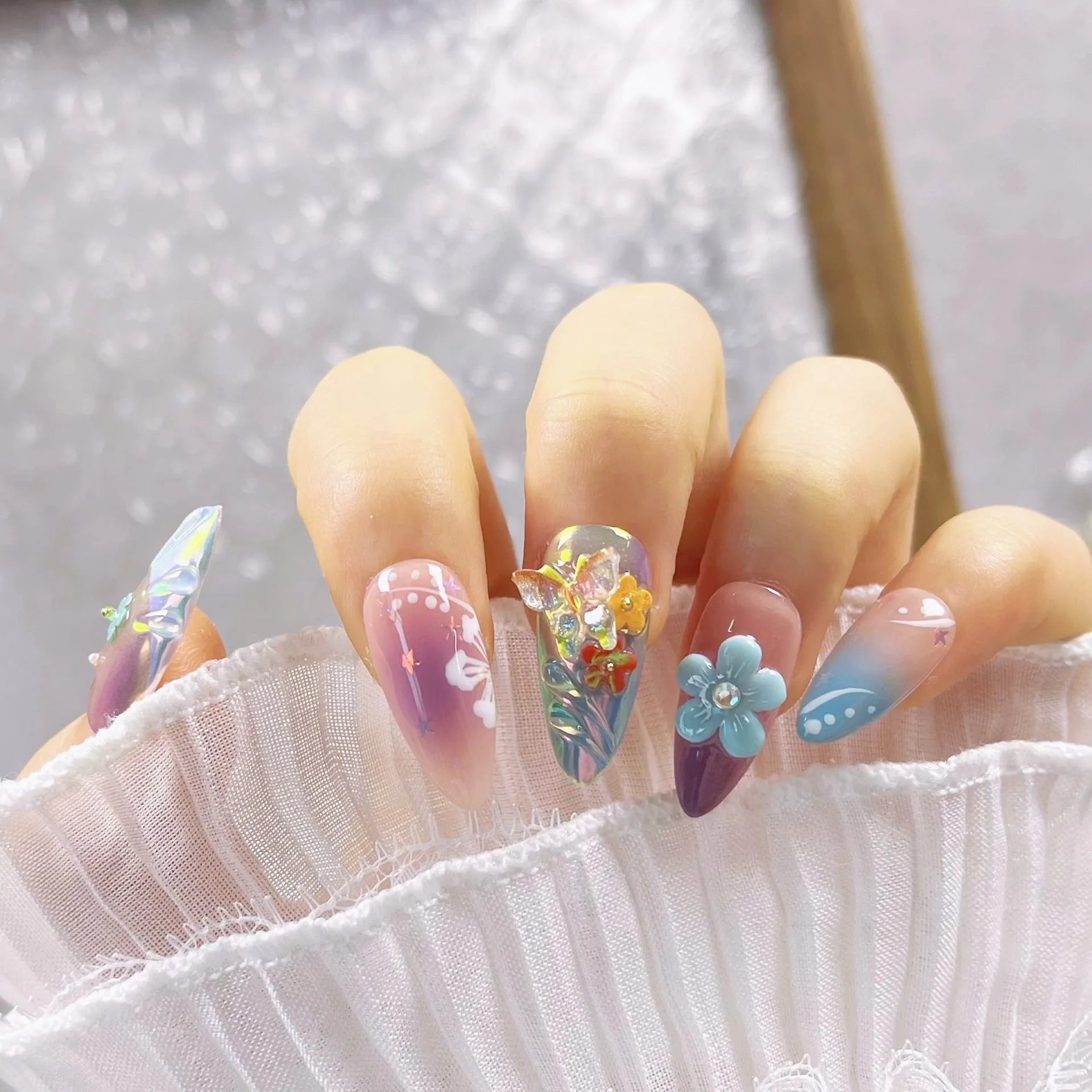 Handmade nail art sculptures with flower and butterfly designs for manicure decoration