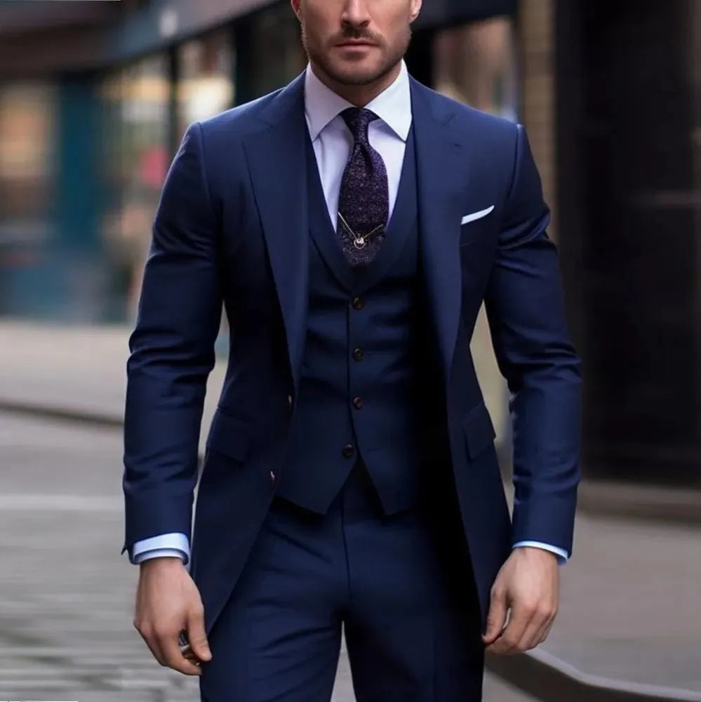 Men's slim fit three-piece suit in a solid colour, showing jacket, waistcoat, and trousers on a hanger.