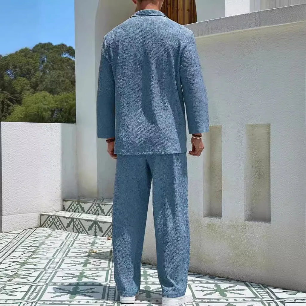 Man wearing a lake blue casual shirt and matching trousers from a polyester suit set.