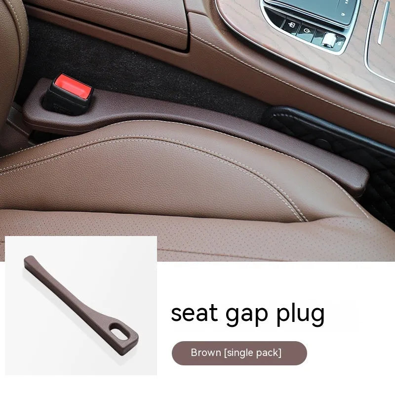 Flexible polyurethane car seat gap filler strip in beige colour on a car seat.