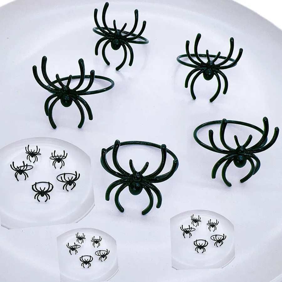 Set of six black spider Halloween napkin rings made from alloy material