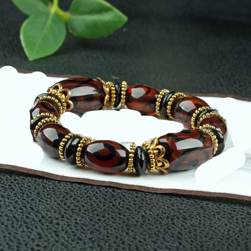 Agate Tibetan dzi bead bracelet with three-eye design and polished finish