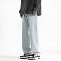 Men's light blue straight leg jeans with button waist closure on size chart