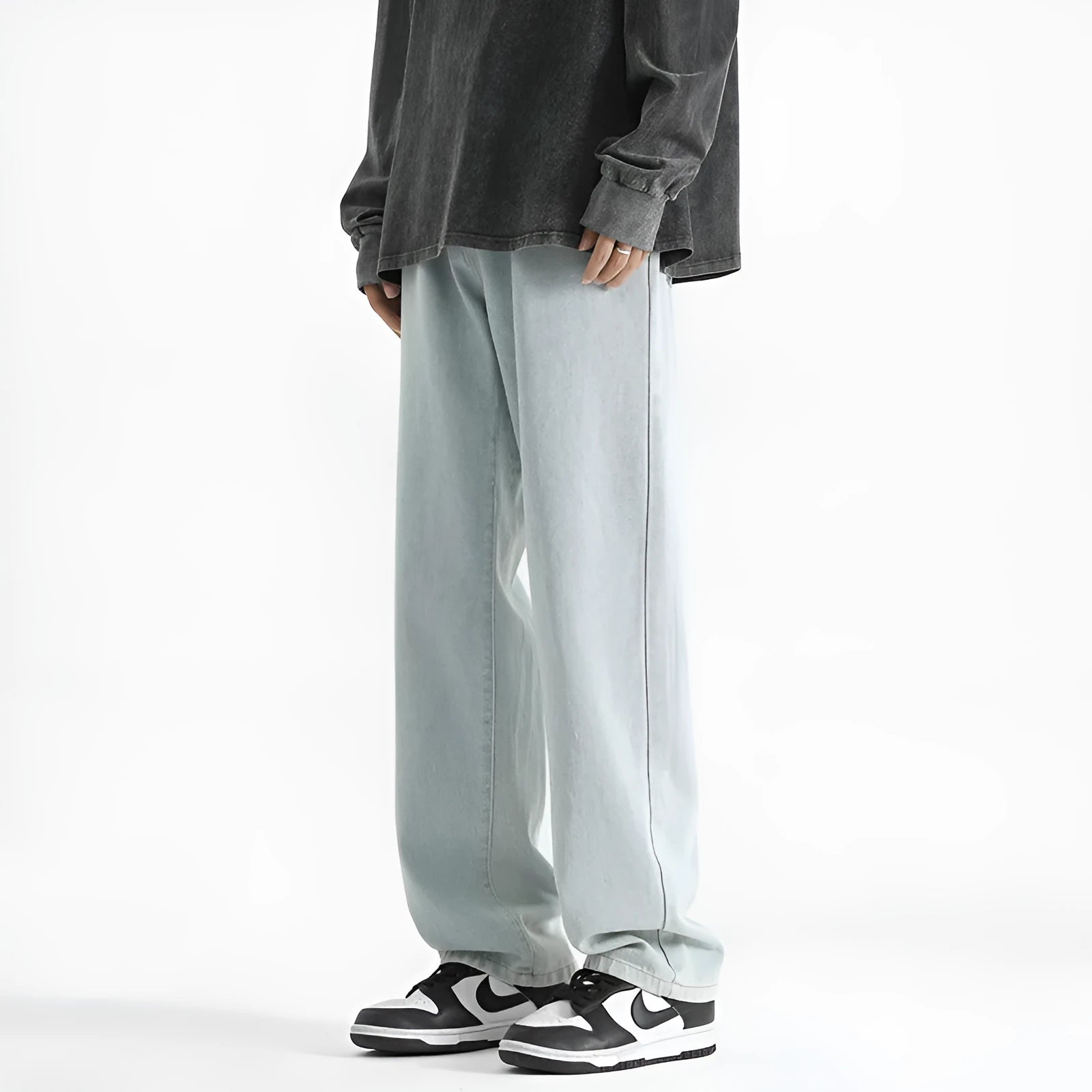 Men's light blue straight leg jeans with button waist closure on size chart