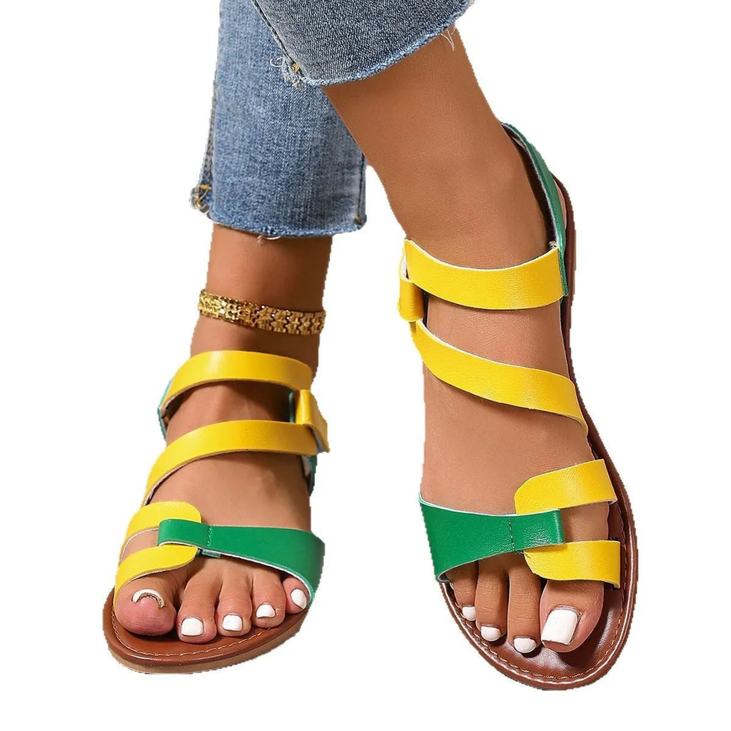 Women's black flat sandals with a Velcro strap closure, round toe, and rubber sole.