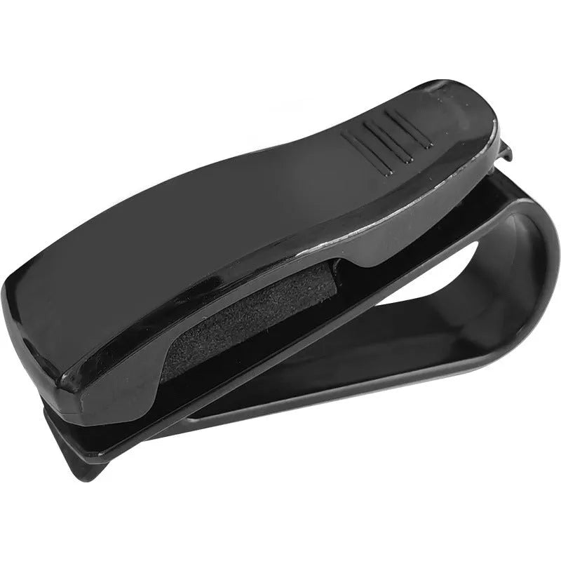 Black plastic multifunctional clip for mounting on a car sunshade to hold glasses, tickets, and ID cards.