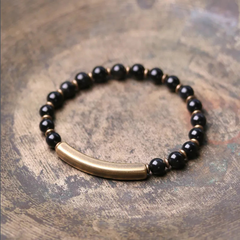 Layered ethnic bracelet with natural agate stones and brass charms on wrist