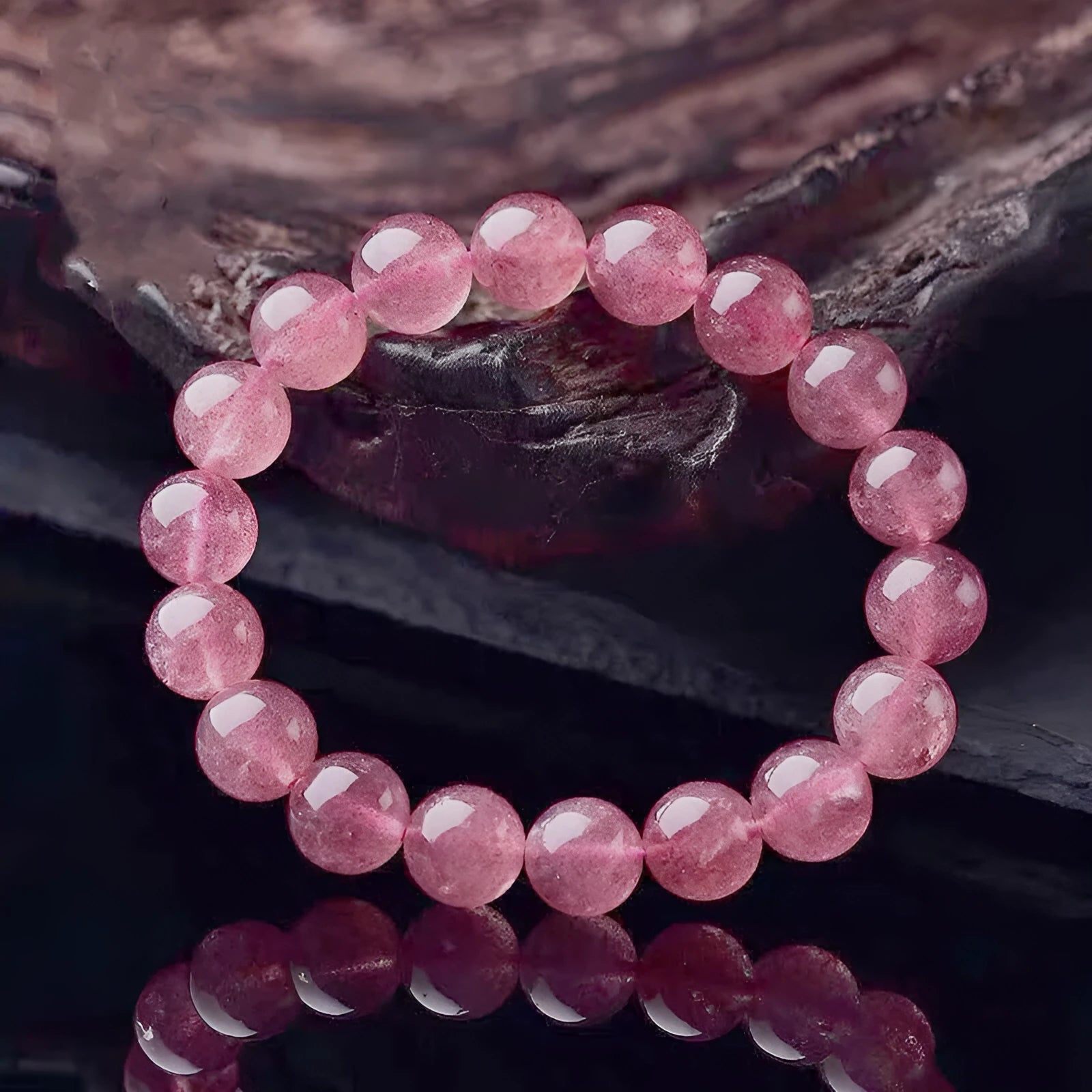 Women's strawberry quartz crystal bracelet with polished beads in three size options.