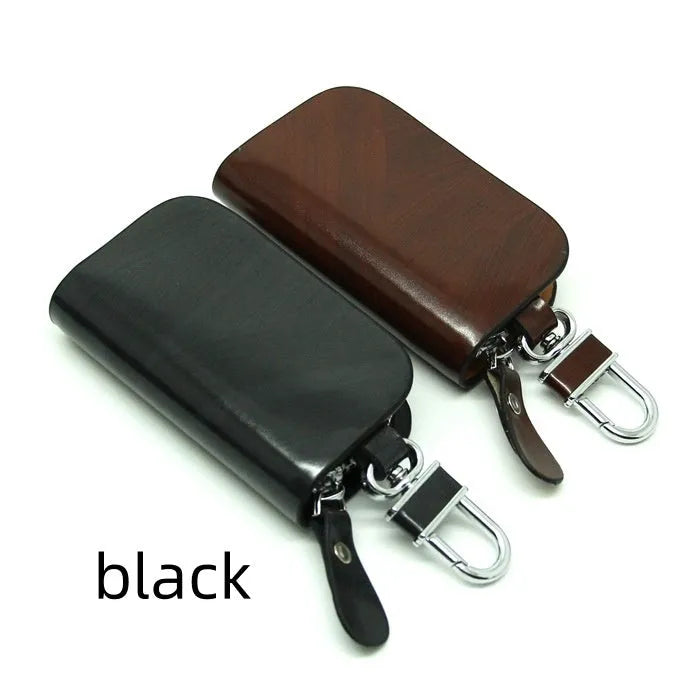 Genuine leather car key case in frost black and brown, showing soft cowhide material and size.