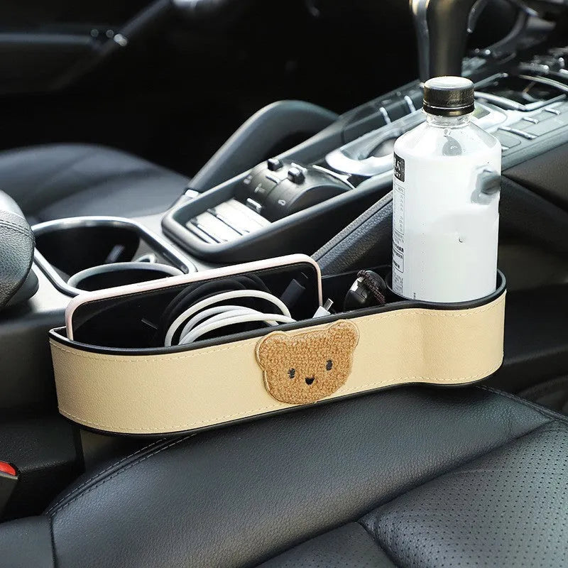Leather car seat gap storage box with cartoon bear design hanging between vehicle front seats