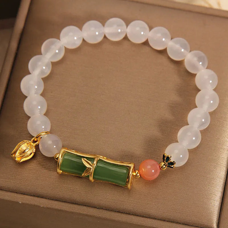 Women's natural style bracelet with jade beads, white agate centrepiece, and bamboo joint detailing.