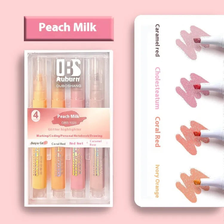 Four glitter highlighter pens with pastel colours and slanted tips on a notebook.