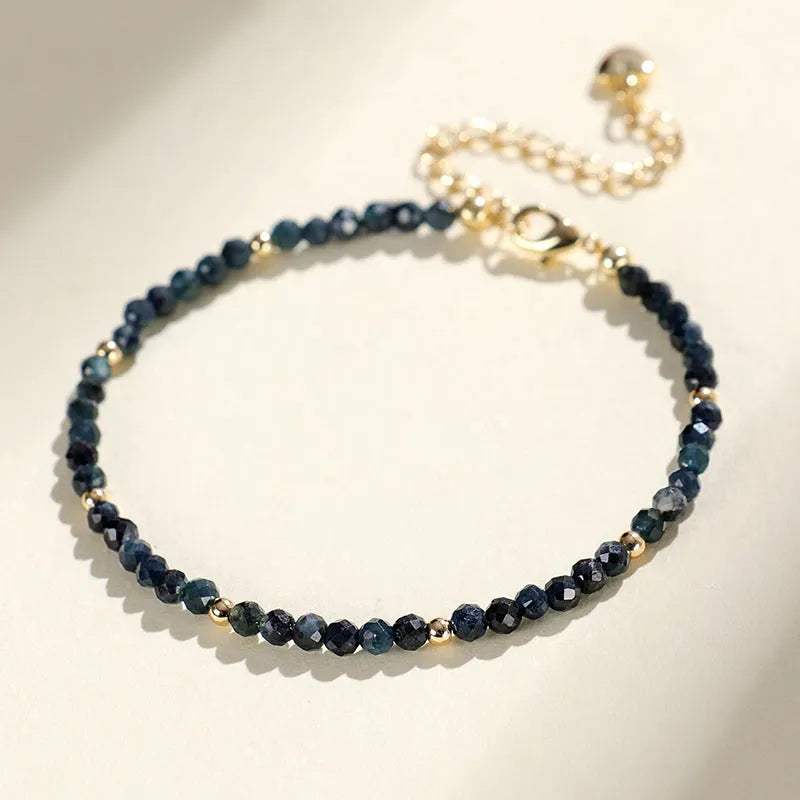Women's blue tourmaline bracelet with 3mm beads and gold spacer beads