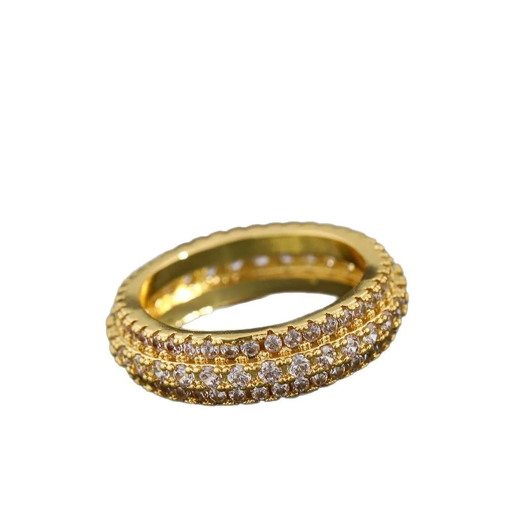 Geometric gang drill style engagement ring with a triangular zircon stone inlay on a metal band.