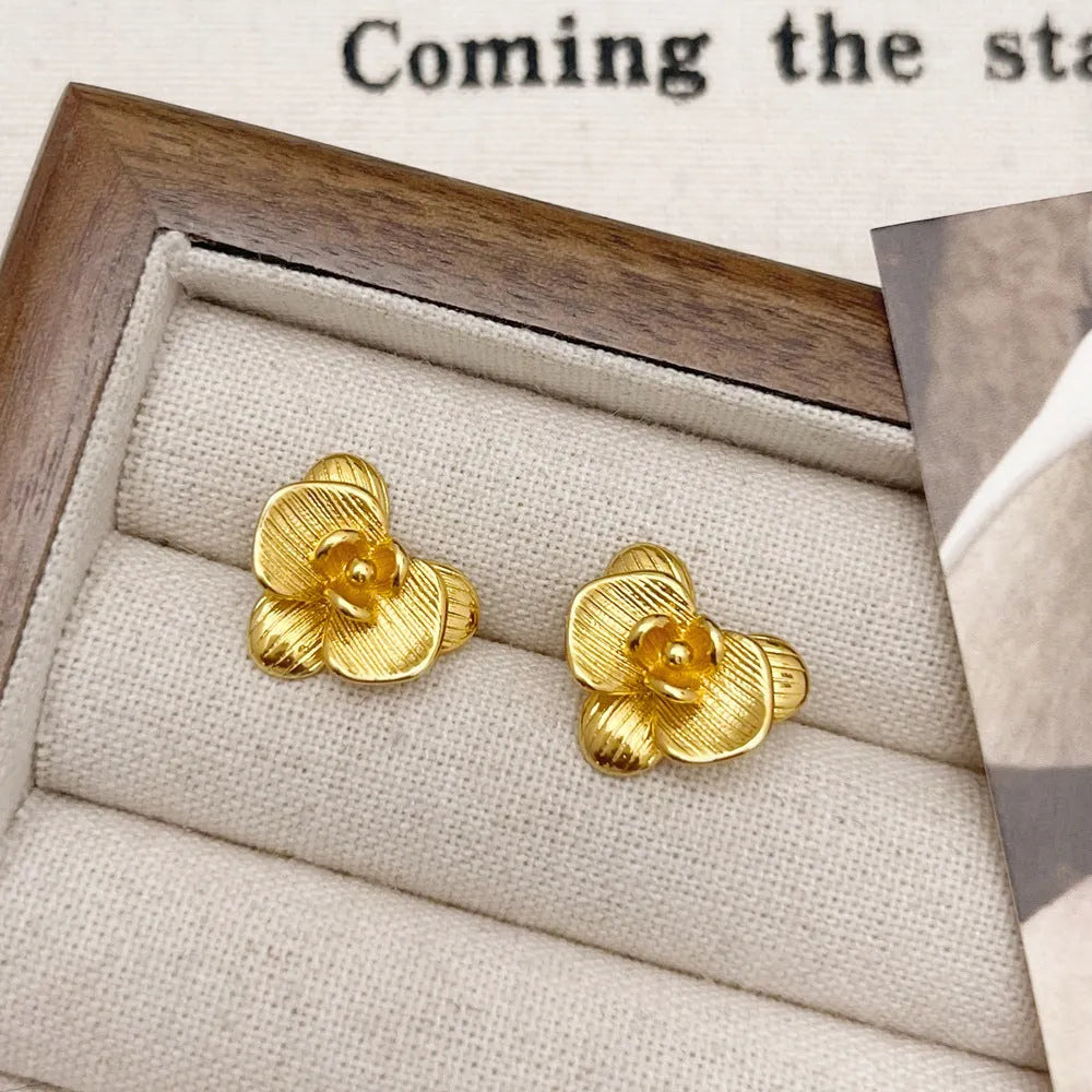 Retro floral fashion earrings in gold or silver colour with petal detailing on copper base.