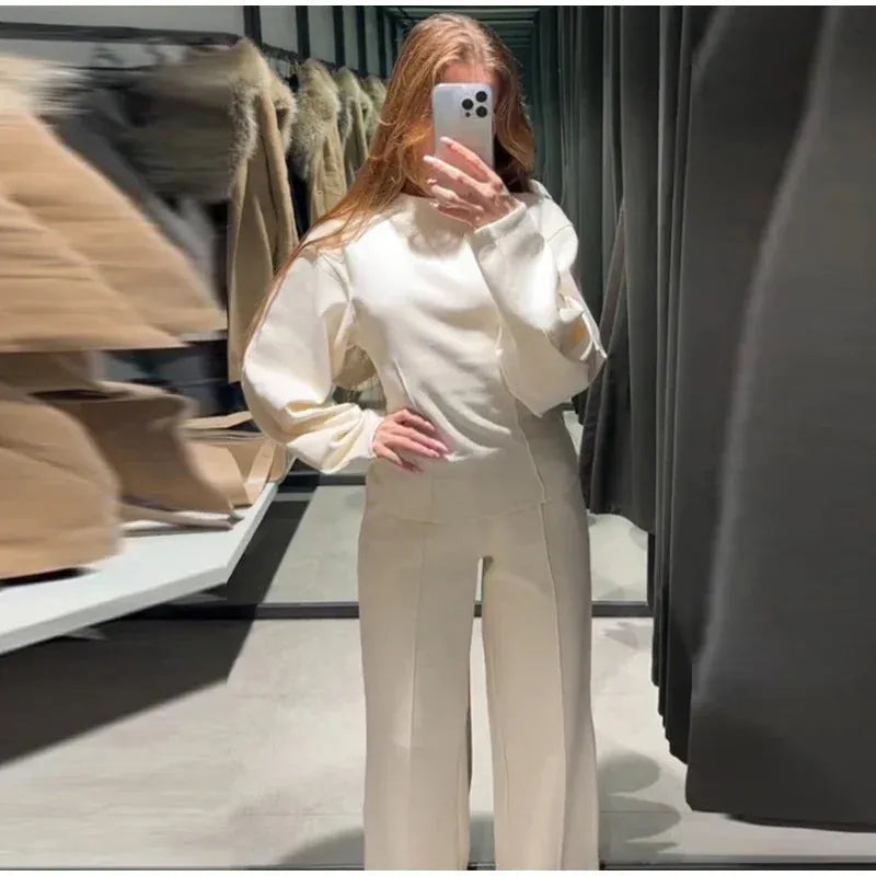 Women's apricot polar fleece suit set with long sleeve top and wide leg trousers on a hanger.