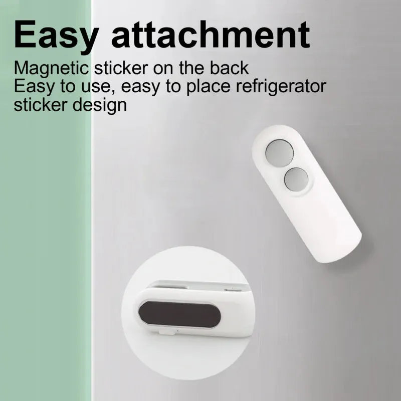 White handheld vacuum sealing machine with USB port and cutter blade on a kitchen counter.