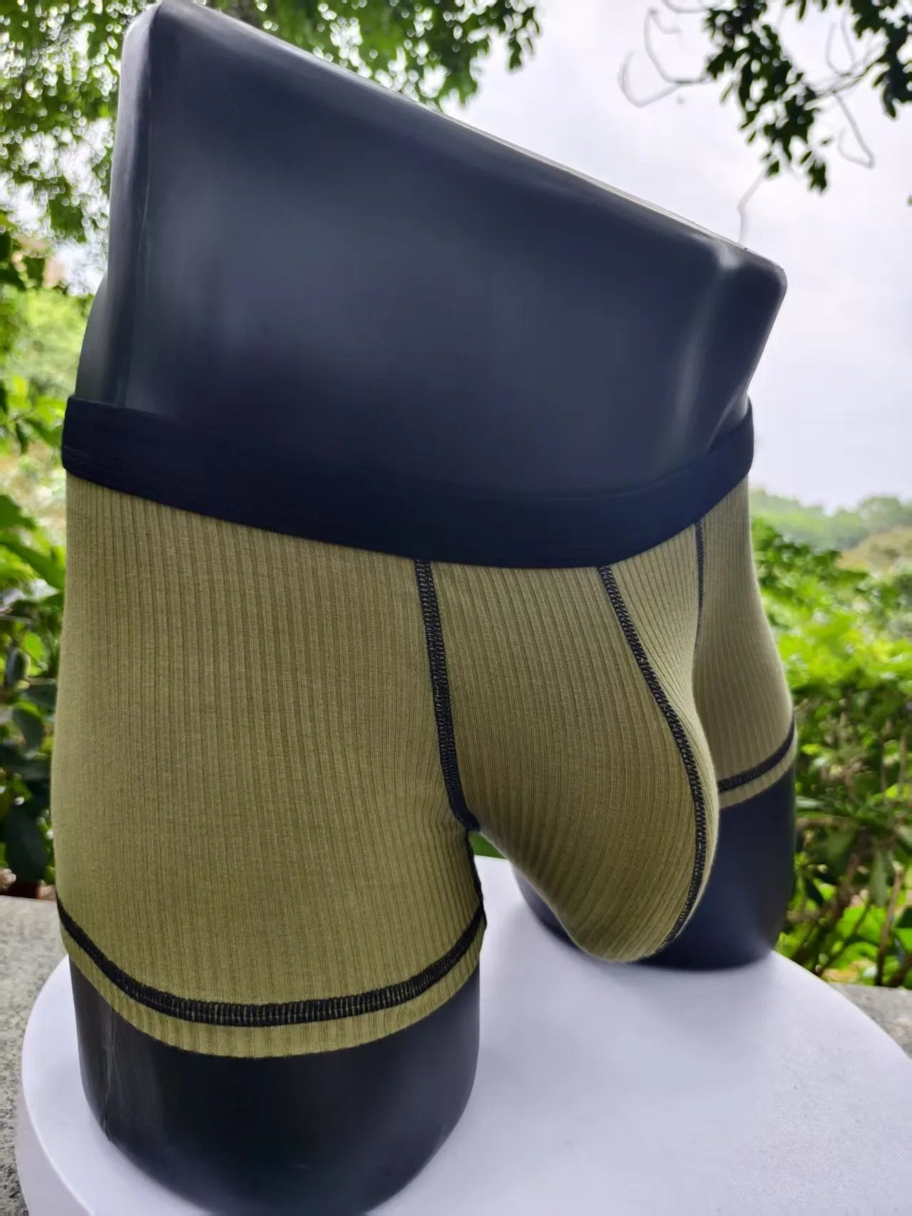 Men's thin fibre boxer shorts in army green, shown laid flat to display hip lift design.