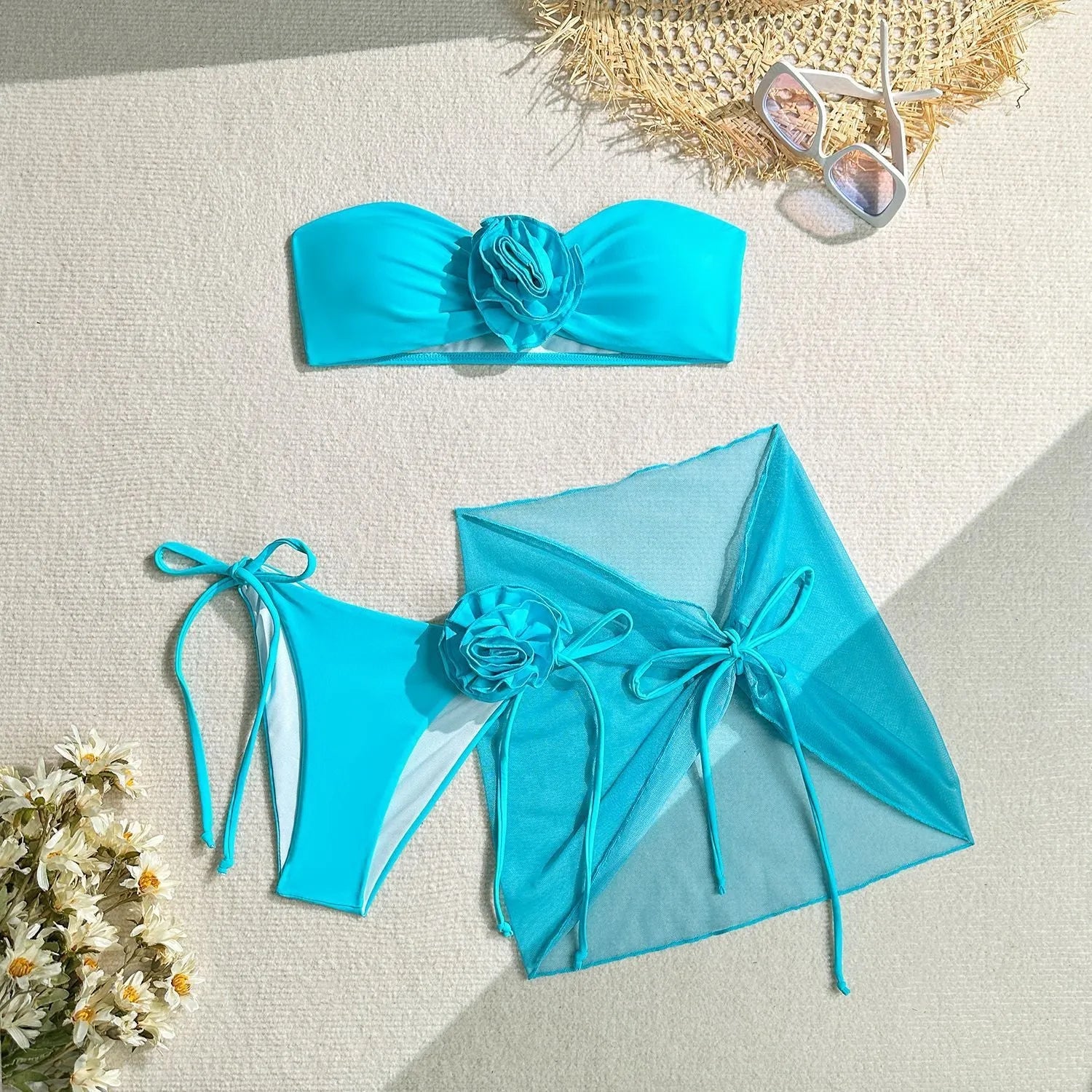 Blue women's tube top swimsuit with big 3D flower tie, matching bottoms, and skirt