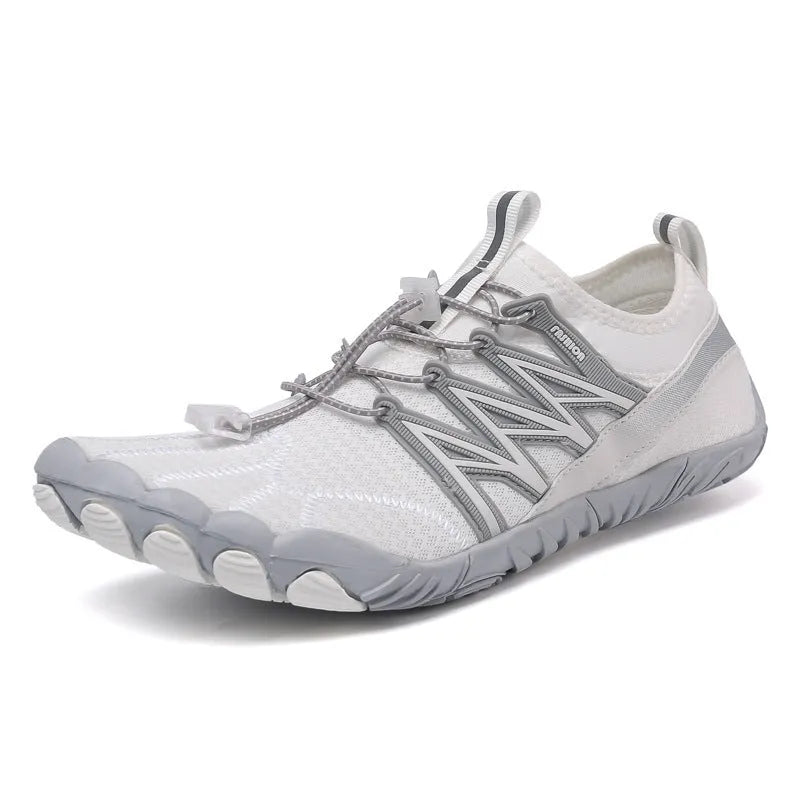 Low-top striped training sneakers with a flat rubber sole, shown in various colours including black and grey orange.