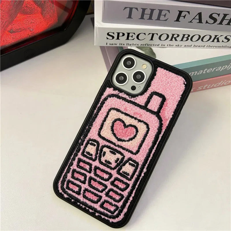 Soft pink TPU iPhone case with a towel-like embroidered texture on the back.