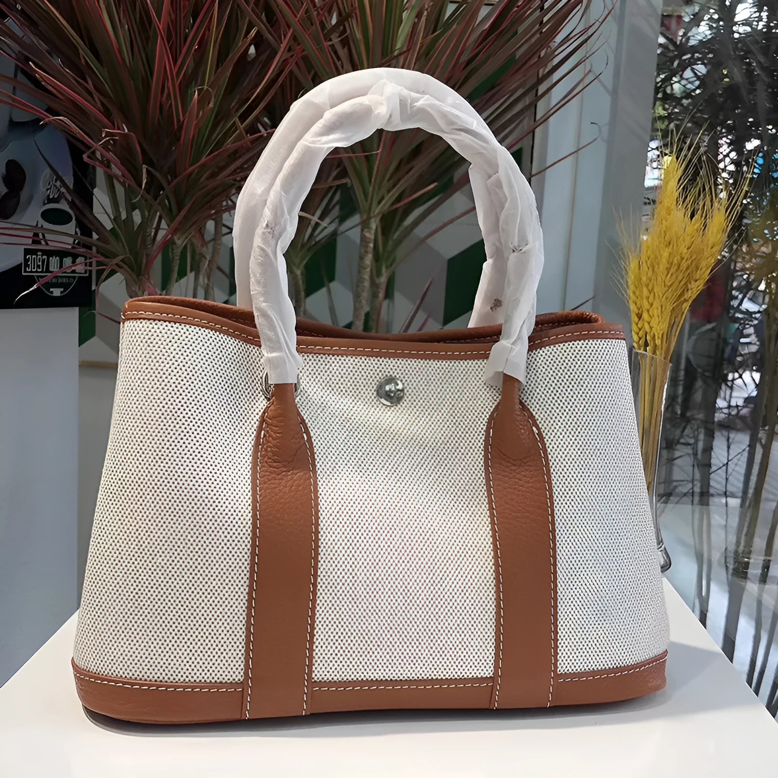 Women's canvas crossbody shoulder tote bag with leather detailing and bucket shape