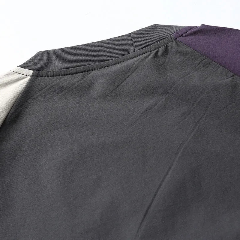 Dark grey men's loose-fit T-shirt with contrast colour raglan sleeves on a hanger.