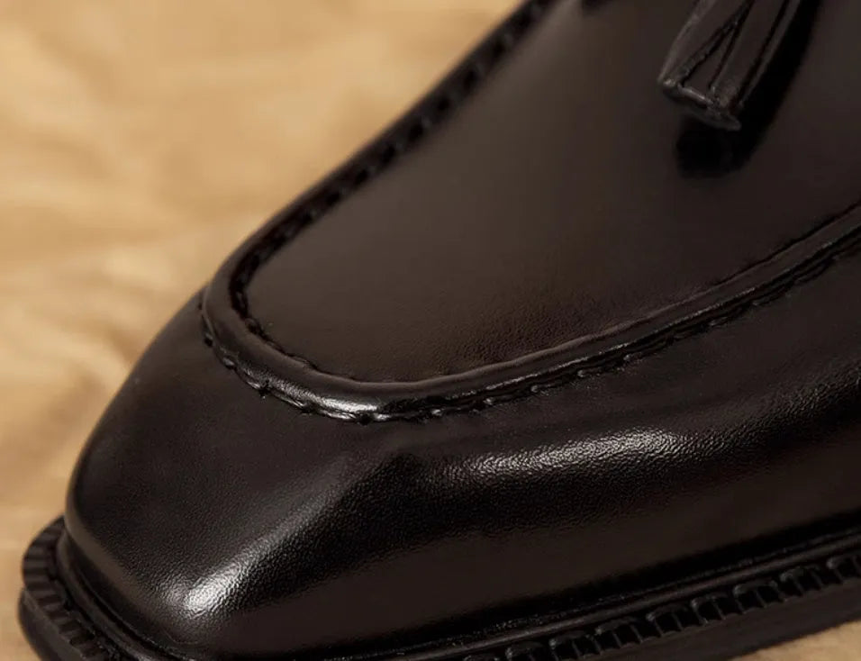 Men's black and brown genuine leather slip-on loafers with a pigskin lining, shown in multiple sizes.