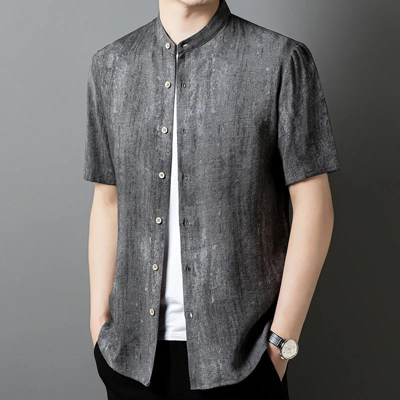 Man wearing a loose grey linen shirt with a stand collar and short sleeves, cardigan style.