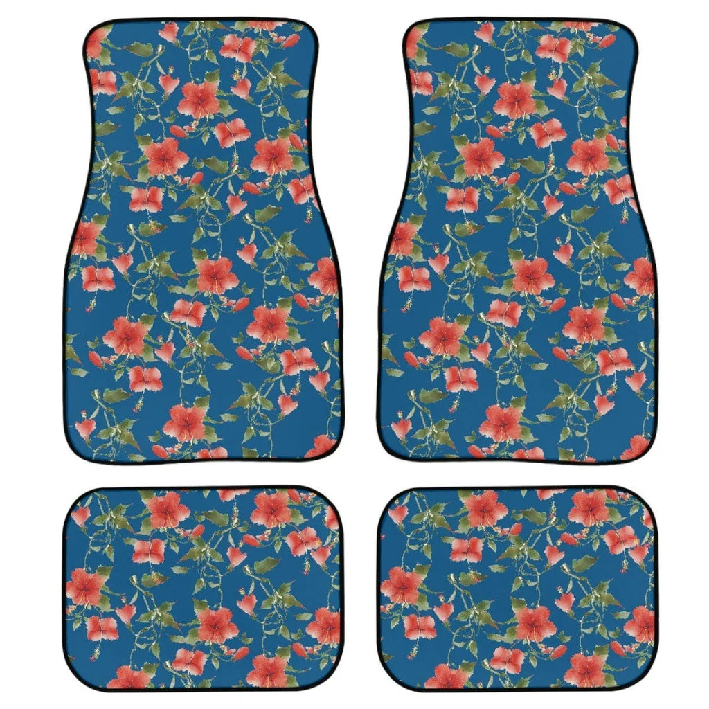 Four-piece set of thick black rubber car floor mats with printed patterns laid out for a vehicle.