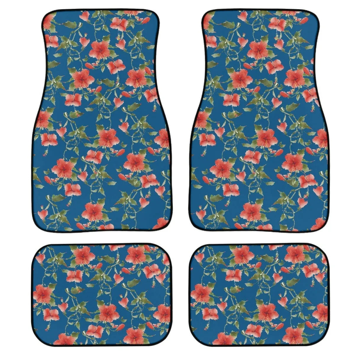 Four-piece set of thick black rubber car floor mats with printed patterns laid out for a vehicle.