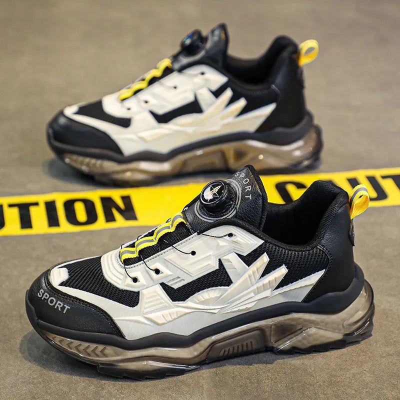 Men's black casual shoes with a rotating button closure and mesh upper on a rubber sole.