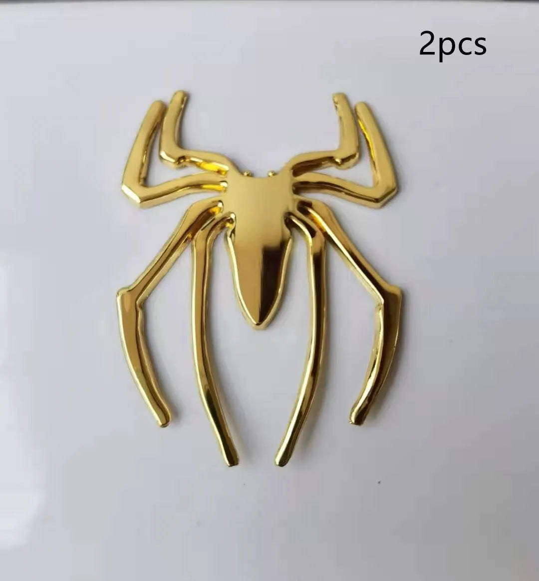 Three-dimensional metal spider sticker in gold colour, measuring 7cm by 5cm.